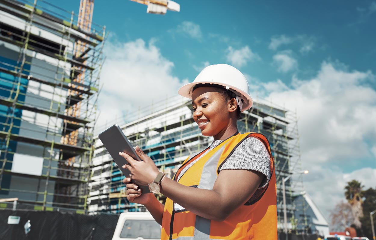 Construction worker who is a female on ipad outside on the jobsite